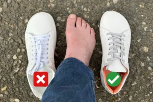 Bare foot next to a narrow barefoot sneaker and a wide barefoot shoe, showing the difference in toe space.