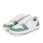 White sneakers with green suede accents on the toe and heel